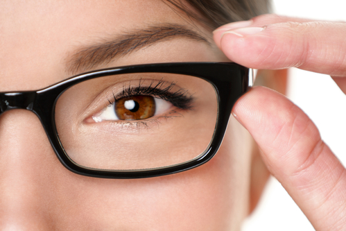 Woman eye with reading glasses